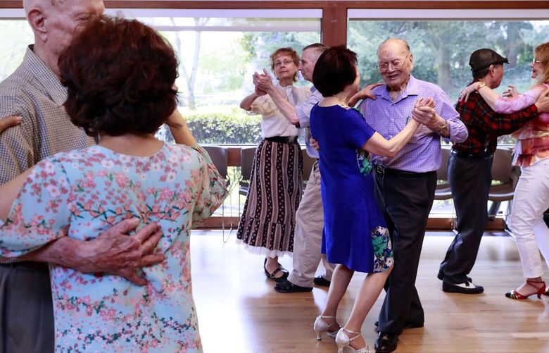 Gene S. Moy, 102, wearing purple, dances with Sanda Chin at the Renton Senior Activity Center’s weekly dance. Dancers range in age from their 50s to centenarians 210283