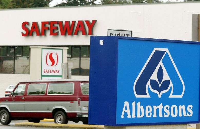Albertsons and Safeway grocery stores stand on opposite sides of a street in Federal Way, Wash., in this photo taken Wednesday, April 23, 2003. A Seattle law firm is suing the country’s three largest grocery chains, including Albertsons and Safeway, contending they failed to disclose to shoppers the coloring additives that turn farm-raised salmon pink.  The three proposed class actions against the Kroger Co., Safeway and Albertsons were filed Wednesday in King County Superior Court, said Paul Kampmeierwith Smith & Lowney.  (AP Photo/John Froschauer) SEF101