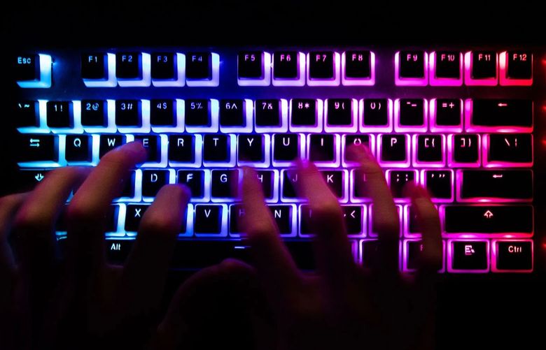 A person typing at a backlit computer keyboard. (Chris Ratcliffe / Bloomberg)