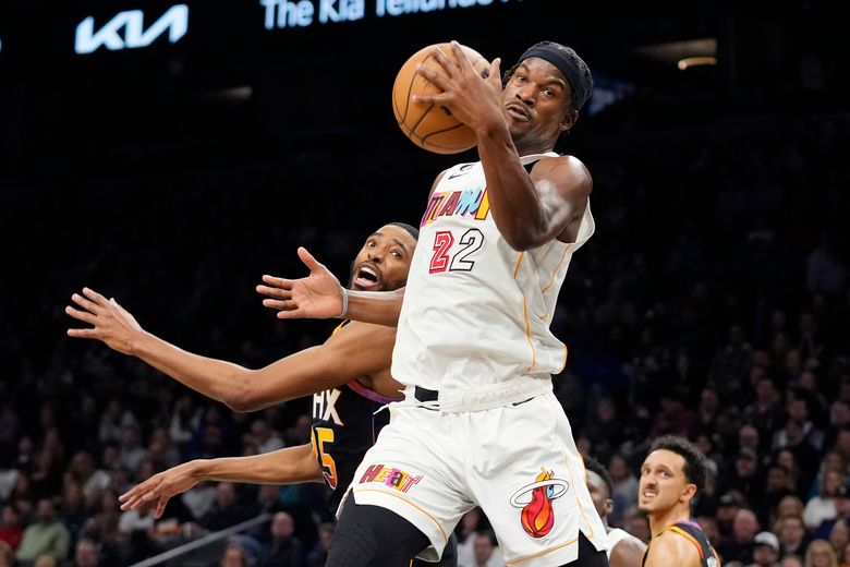 Miami Heat guard Victor Oladipo, right, looks for an opening past