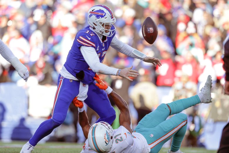 Buffalo Bills quarterback Josh Allen (17) hands off the ball to