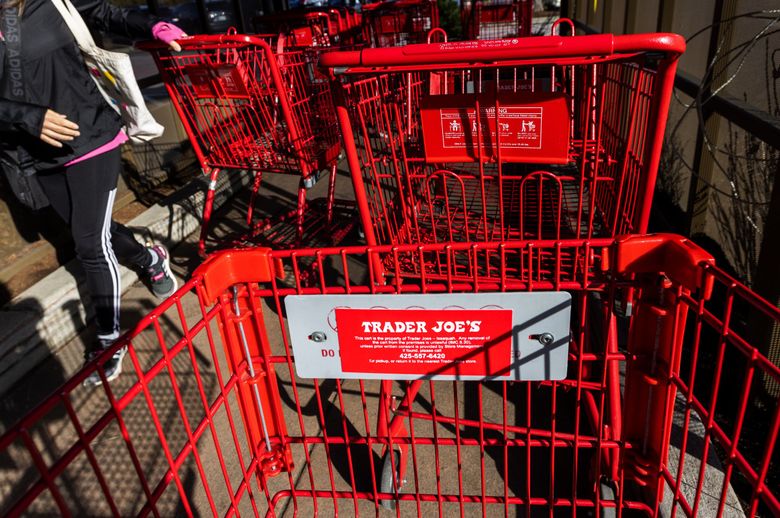 An anti-cart theft regulation is posted on each Trader Joe’s cart at Issaquah Commons shopping center. In early 2022, Issaquah began holding large retailers responsible for their carts. (Ken Lambert / The Seattle Times)