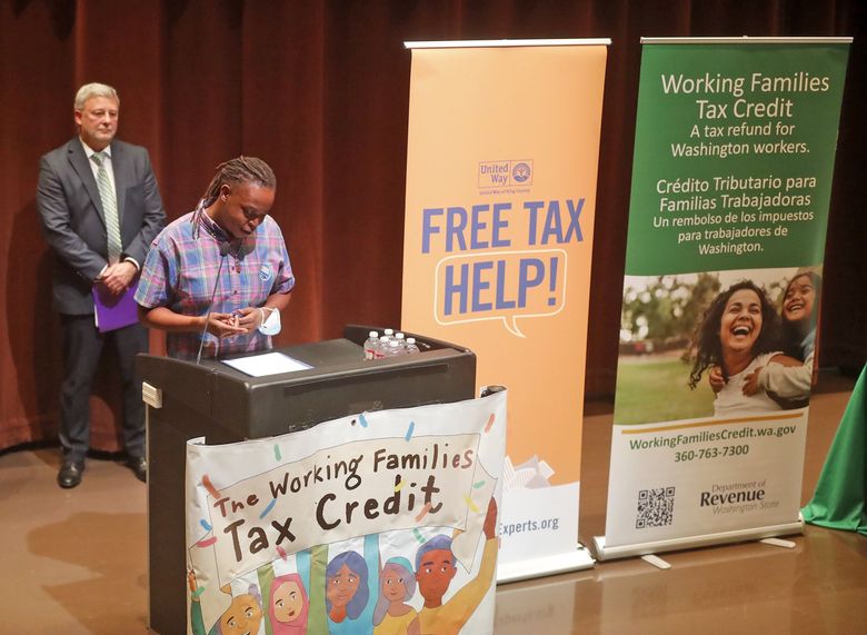 Olympic College student Nijhia Jackson describes how the Working Families Tax Credit will provide extra assistance for her family during a news conference Wednesday at the Central Library downtown. At left is  John Ryser, acting director of the state’s Department of Revenue. (Greg Gilbert / The Seattle Times)