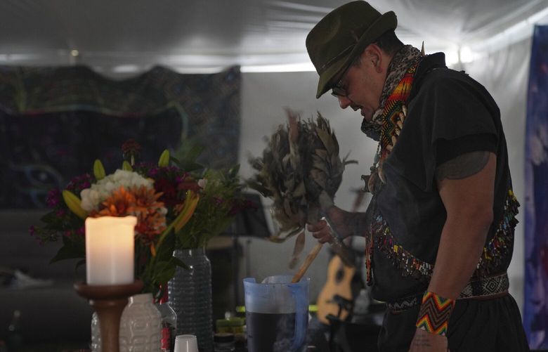 Colombian shaman Taita Pedro Davila, leads an ayahuasca ceremony with Hummingbird Church, in Hildale, Utah, on Sunday, Oct. 16, 2022. Following the traditions of his grandfather in Colombia, Davila prays, chants, and sings in Spanish and the language of the Kamëntsá people over the psychoactive brew before serving it to individual participants. (AP Photo/Jessie Wardarski) NYJW307 NYJW307