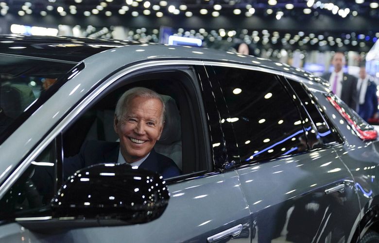 FILE – President Joe Biden drives a Cadillac Lyriq through the showroom during a tour at the Detroit Auto Show, Sept. 14, 2022, in Detroit. Ratcheting  up his criticism of the Biden administration, Democratic Sen. Joe Manchin introduced legislation Wednesday to delay new tax credits for electric vehicles, a key feature of President Joe Biden’s landmark climate law. Manchin said guidelines issued by the Treasury Department allow manufacturers in Europe and other countries to bypass requirements that significant portions of EV batteries must be produced in North America. (AP Photo/Evan Vucci, File) WX102 WX102