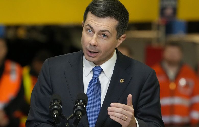 FILE – Transportation Secretary Pete Buttigieg speaks before the arrival of President Joe Biden at the construction site of the Hudson Tunnel Project, Tuesday, Jan. 31, 2023, in New York. Nearly 50 businesses and nonprofits including rideshare companies Uber and Lyft, industrial giant 3M and automaker Honda are pledging millions of dollars in initiatives to stem a “crisis” in road fatalities under a new federal effort announced Friday, Feb. 3. (AP Photo/John Minchillo) WX201 WX201