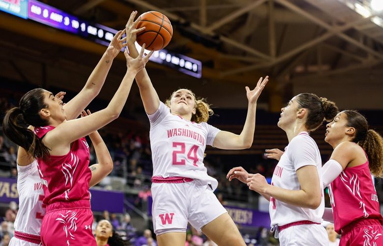 Washington’s Elle Ladine pulls down the offensive board in the first quarter. 222944