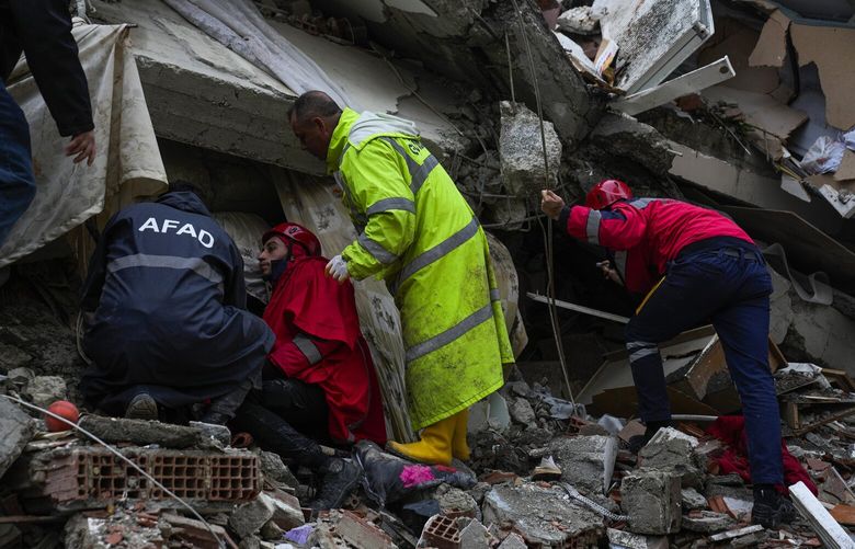 Emergency teams search for people through the rubble of a destroyed building in Adana, Turkey, Monday, Feb. 6, 2023. A powerful quake has knocked down multiple buildings in southeast Turkey and Syria and many casualties are feared. (AP Photo/Khalil Hamra) FS118 FS118