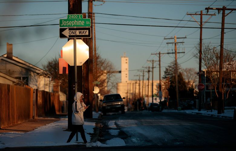 Pedestrians walk a street in the Elyria-Swansea neighborhood in Denver, Colorado. MUST CREDIT: Photo for The Washington Post by Matthew Staver.