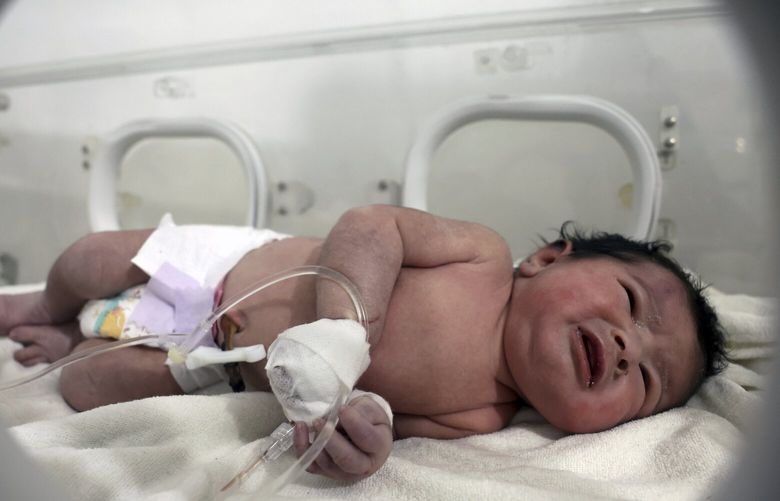 A baby girl who was born under the rubble caused by an earthquake that hit Syria and Turkey receives treatment inside an incubator at a children’s hospital in the town of Afrin, Aleppo province, Syria, Tuesday, Feb. 7, 2023. Residents in the northwest Syrian town discovered the crying infant whose mother gave birth to her while buried underneath the rubble of a five-story apartment building levelled by this week’s devastating earthquake, relatives and a doctor say.  (AP Photo/Ghaith Alsayed) XBH105 XBH105