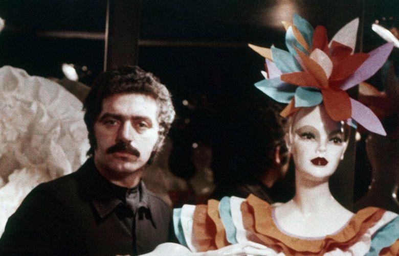 FILE – Waxwork mannequins were used by Paris couturier Paco Rabanne for the presentation of his 1973 collection of paper dresses, Jan. 22, 1973. The Spanish-born pace-setting designer known for perfumes sold worldwide and his metallic, space-age fashions, has died, the group that owns his fashion house announced on its website Friday Feb.3, 2023. He was 88. (AP Photo/Bernard Ferret, File) XPAR108 XPAR108