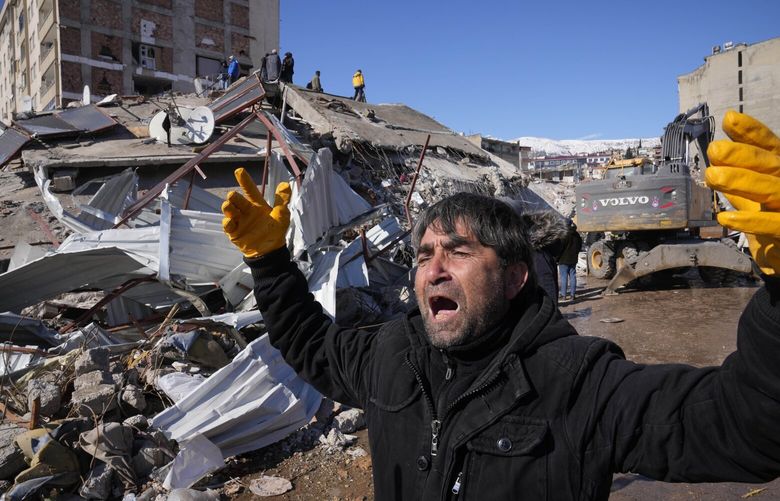 A man reacts, after rescue teams found his father dead under a collapsed building, in Kahramanmaras, southern Turkey, Wednesday, Feb. 8, 2023. Nearly two days after the magnitude 7.8 quake struck southeastern Turkey and northern Syria, thinly stretched rescue teams work to pull more people from the rubble of thousands of buildings. (AP Photo/Hussein Malla) XTS148 XTS148