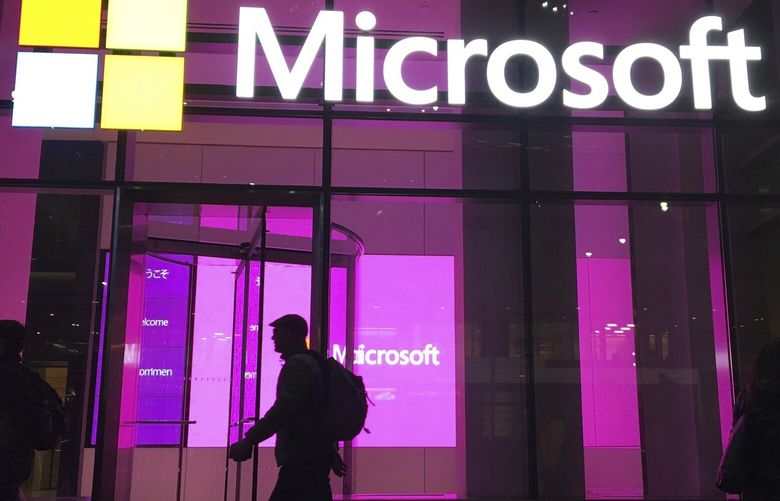 FILE – In this Nov. 10, 2016, file photo, people walk past a Microsoft office in New York. Microsoft on Oct. 7, 2021, says Russia once again accounted for most state-sponsored hacking, with a 58% share of intrusion attempts it detected in the past year. The targets were mostly government agencies — in the United States, followed by Ukraine, Britain and European NATO members.