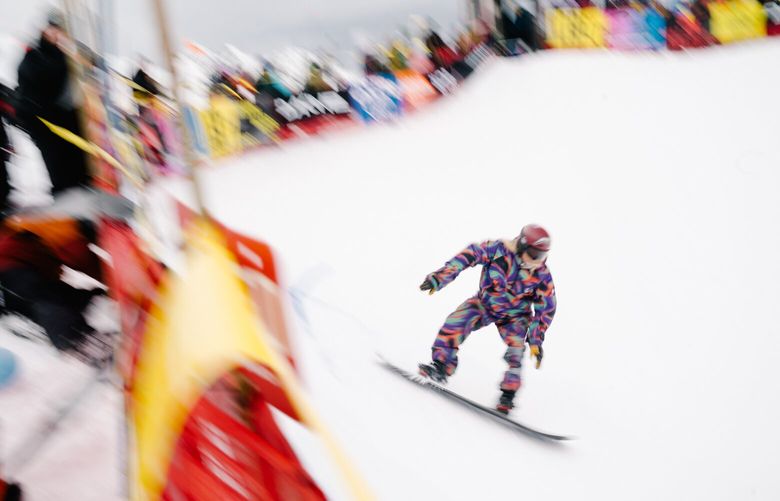 Mount Baker – A racer speeds past spectators at the top of Mount Baker’s Legendary Banked Slalom before falling in the first turn. Some participants noted difficult conditions early in the competition before a storm brought fresh snow to the race course later in the day. – 020223