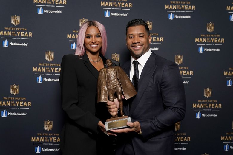 Seattle Seahawks quarterback Russell Wilson and his wife Ciara pose for a photo after Wilson won the Walter Payton NFL Man of the Year awards at the NFL Honors ceremony as part of Super Bowl 55 Friday, Feb. 5, 2021, in Tampa, Florida. (AP Photo/Charlie Riedel)