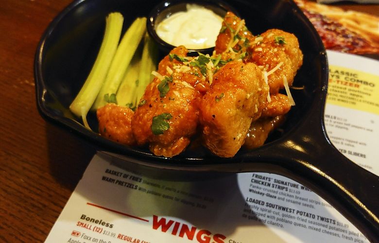 An order of “boneless chicken wings” is shown at a restaurant in Willow Grove, Pa., Wednesday, Feb. 8, 2023. With the Super Bowl at hand, behold the cheerful untruth that has been perpetrated upon (and generally with the blessing of) the chicken-consuming citizens of the United States on menus across the land: a “boneless wing” that isn’t a wing at all. (AP Photo/Matt Rourke) 