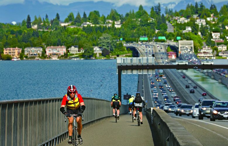 Bicycle riders on I-90 bridge. Mercer Island bike loop. Pacific Northwest Magazine Fitness column. Nicole Tsong writer. Story ID: