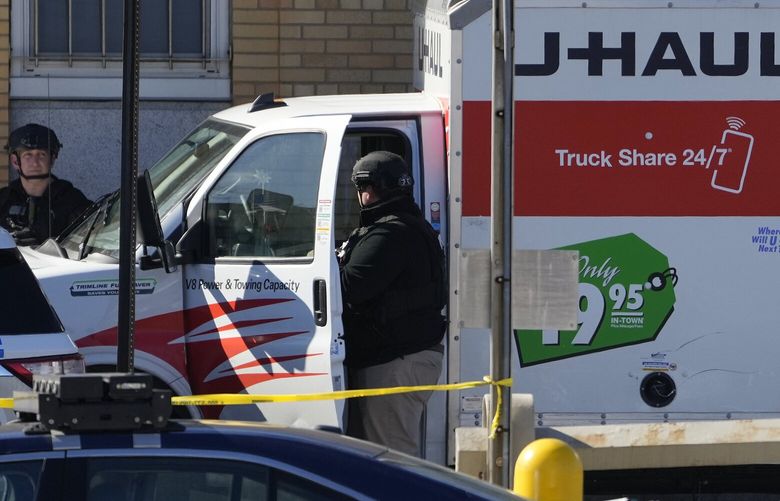 Members of the NYPD bomb squad examine a rental truck that was stopped and the driver arrested, Monday, Feb. 13, 2023, in New York. Police stopped a U-Haul truck and detained the driver after reports that the vehicle struck multiple pedestrians in New York City on Monday. Authorities say the driver of the truck fled the scene after mounting a sidewalk in the Bay Ridge neighborhood of Brooklyn and injuring several people. (AP Photo/John Minchillo) NYJJ106 NYJJ106