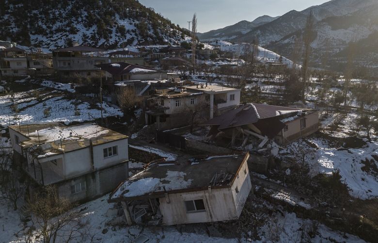 Destroyed houses in the Kayabasi village, Turkey, on Feb. 13, 2023. In rural southern Turkey, some villages were cut off from aid for days and locals were left to fend for themselves after the earthquake. (Sergey Ponomarev/The New York Times) XNYT18 XNYT18