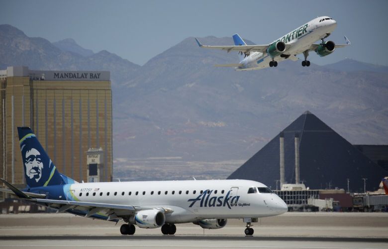 FILE – Planes take off and land from McCarran International Airport in Las Vegas on July 17, 2020. The airport handling travelers to and from Las Vegas handled a record 52.7 million passengers in 2022. That’s according to year-end data reported on Monday, Feb. 6, 2023, by Harry Reid International Airport. (AP Photo/John Locher, File) LA203 LA203