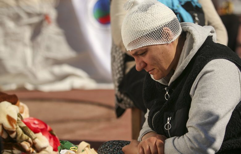 A quake survivor sits at a tented camp set up in Adiyaman, southern Turkey, Monday, Feb. 13, 2023. Thousands left homeless by a massive earthquake that struck Turkey and Syria a week ago packed into crowded tents or lined up in the streets Monday for hot meals as the desperate search for survivors entered what was likely its last hours. (AP Photo/Emrah Gurel) ANK105 ANK105