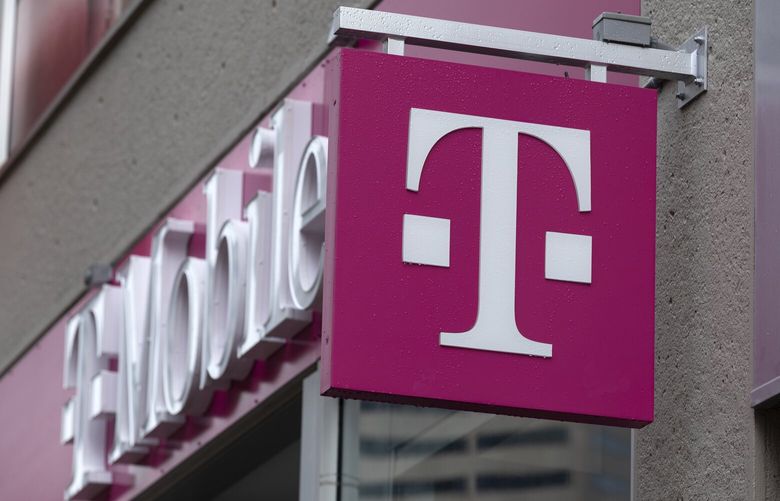 FILE – The T-Mobile logo is seen on a storefront, on Oct. 14, 2022, in Boston. Customers of the wireless provider reported widespread service outages in the U.S. late Monday, Feb. 13, 2023, according to websites tracking service interruptions. (AP Photo/Michael Dwyer, File) NYCD201 NYCD201
