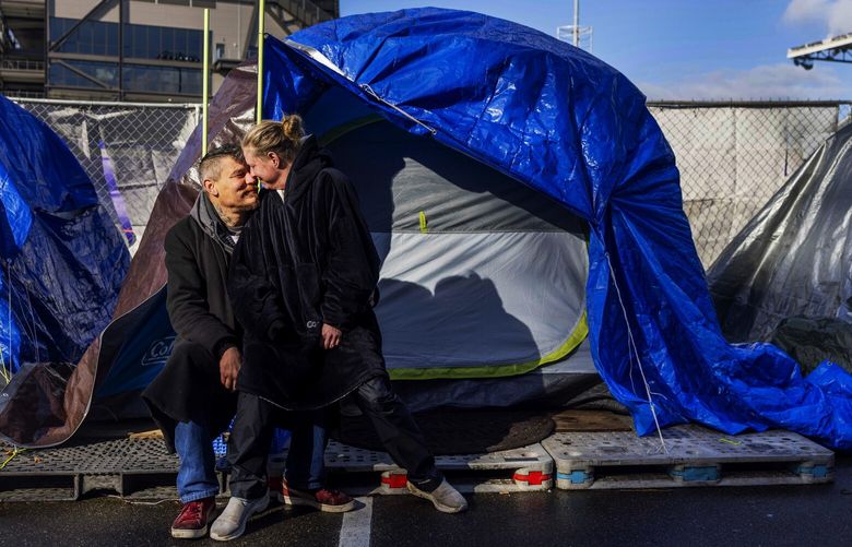 Johnny Zukov and Dayna Bolin, who are experiencing houselessess, are photographed in front of their tent at the University of Washington on Valentine’s Day. 
—
Photographed on Tuesday, Feb. 14, 2023.
