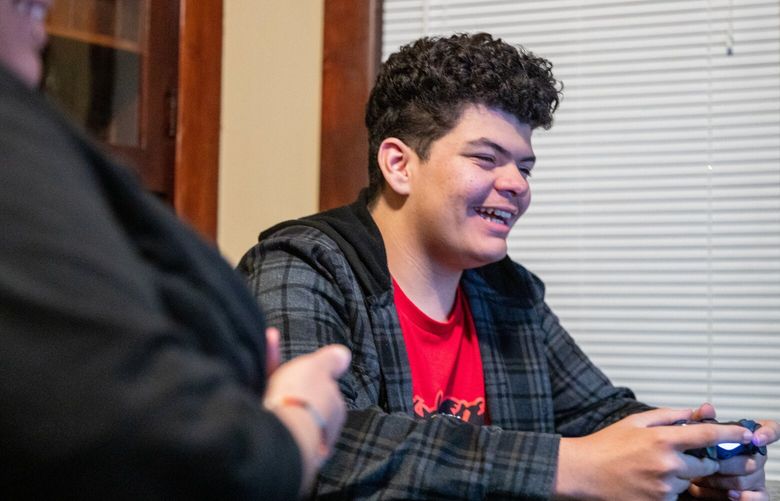 ElijahKing was kept out of Northwest SOIL by his mother, Megan Cummings, left, and with the help of lawyers who took on her case pro bono. Shortly after King first enrolled at Tacoma Public Schools, the district tried to push him to Northwest SOIL. Photographed at his home in Tacoma, Washington on December 16, 2022.