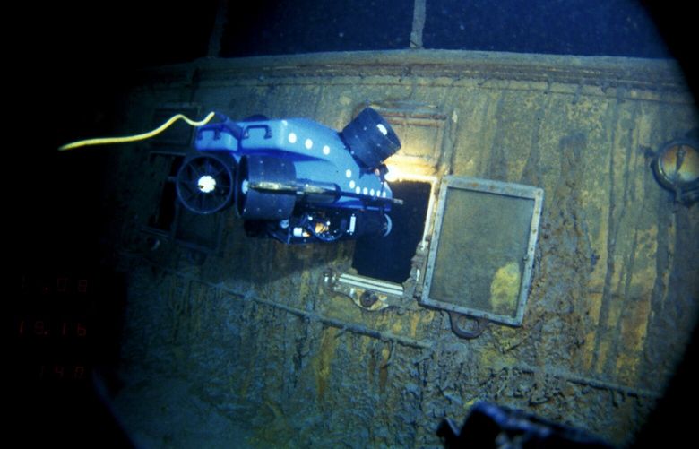 In this image provided by the Woods Hole Oceanographic Institution, an underwater remote vehicle examines an open window of the Titanic 12,500 feet (3.8 kilometers) below the surface of the ocean, 400 miles (640 kilometers) off the coast of Newfoundland, Canada in 1986. Rare and in some cases never before publicly seen video of the dive is being released on Wednesday, Feb. 15, 2023, by the Woods Hole Oceanographic Institution. (Woods Hole Oceanographic Institution via AP) BX603 BX603