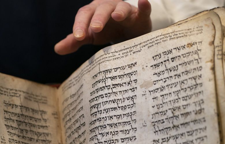 Sotheby’s unveils the Codex Sassoon for auction, Wednesday, Feb. 15, 2023, in the Manhattan borough of New York. The auction house is billing the lot as the “earliest, most complete Hebrew Bible ever discovered.” (AP Photo/John Minchillo) NYJM105 NYJM105