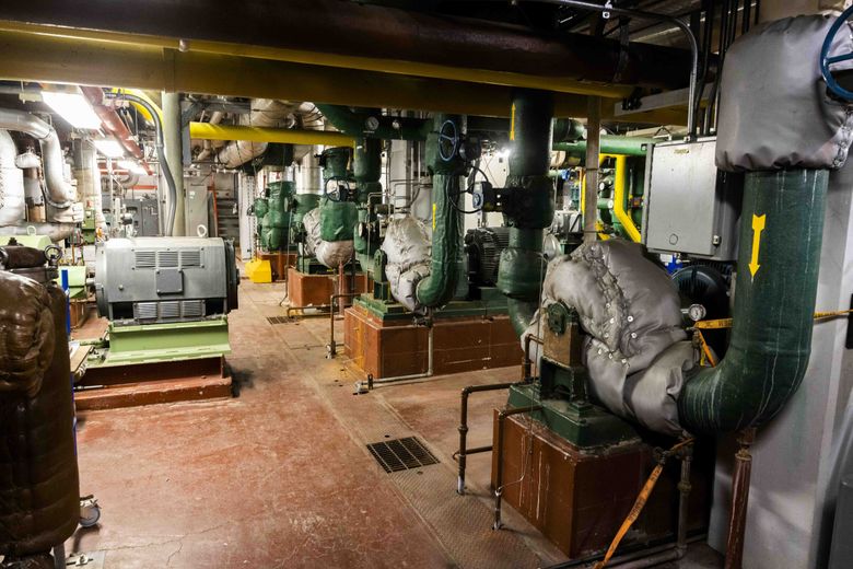 Large water pumps are underground at the University of Washington’s steam plant. (Daniel Kim / The Seattle Times)