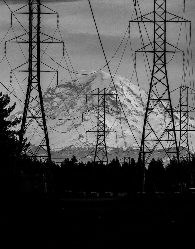 High-voltage transmission lines carry electricity over vast distances. Local utilities argue that sourcing more and more renewable energy from across the West will be key to decarbonizing our grid — while keeping reliable power. (Ken Lambert / The Seattle Times)