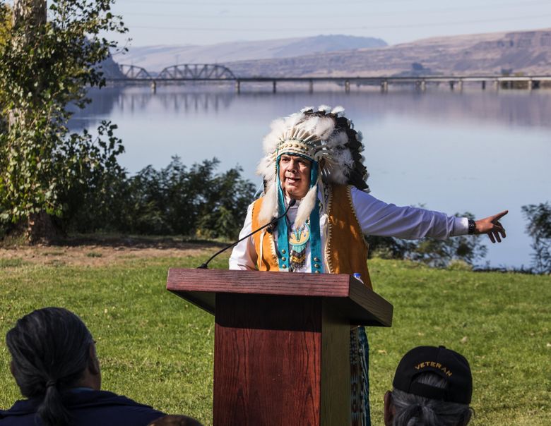 JoDe Goudy, Chairman of the Yakama Indian Nation, points toward the Columbia River while calling for the removal of the Bonneville, John Day and The Dalles dams, stating, ”Dams or salmon” during an Indigenous Peoples Day gathering at Celilo Village park. (Steve Ringman / The Seattle Times, 2019)