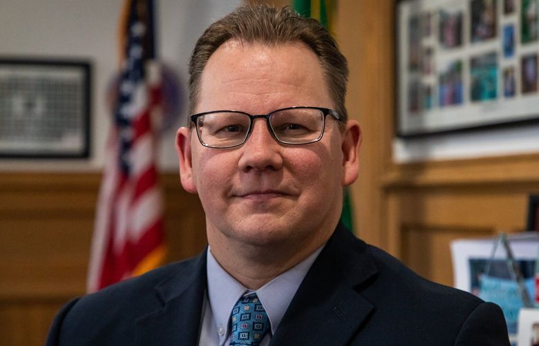 Washington Superintendent of Public Instruction Chris Reykdal poses for a portrait in his office in Olympia on Friday, Jan. 6, 2023. It’s decorated with family photos, historic photos and knickknacks he’s received throughout the years during school visits.