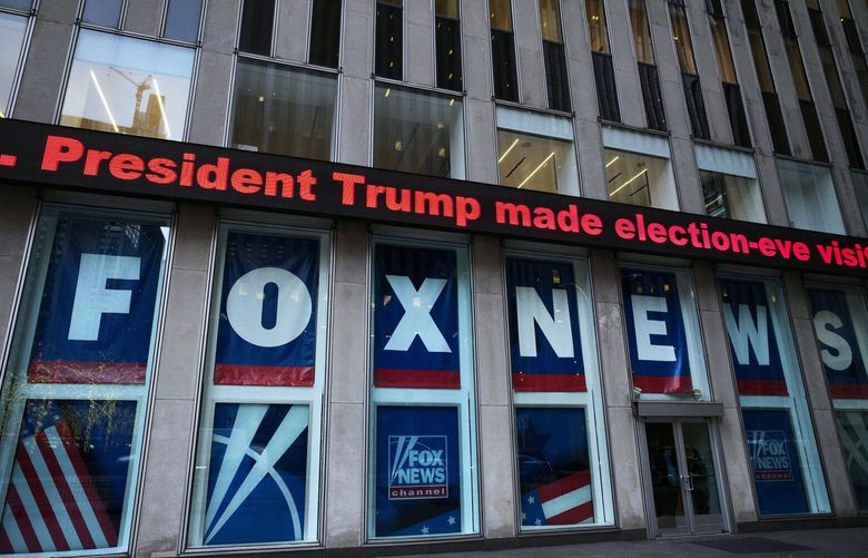 FILE – A headline about President Donald Trump is displayed outside Fox News studios, on Nov. 28, 2018, in New York. On Thursday, Feb. 16, the voting machine company Dominion filed court papers documenting that numerous Fox News personalities knew there was no evidence to support the claims peddled by Trump’s allies, but aired them anyway on the nation’s most-watched cable network.  (AP Photo/Mark Lennihan, File) NYSS417 NYSS417