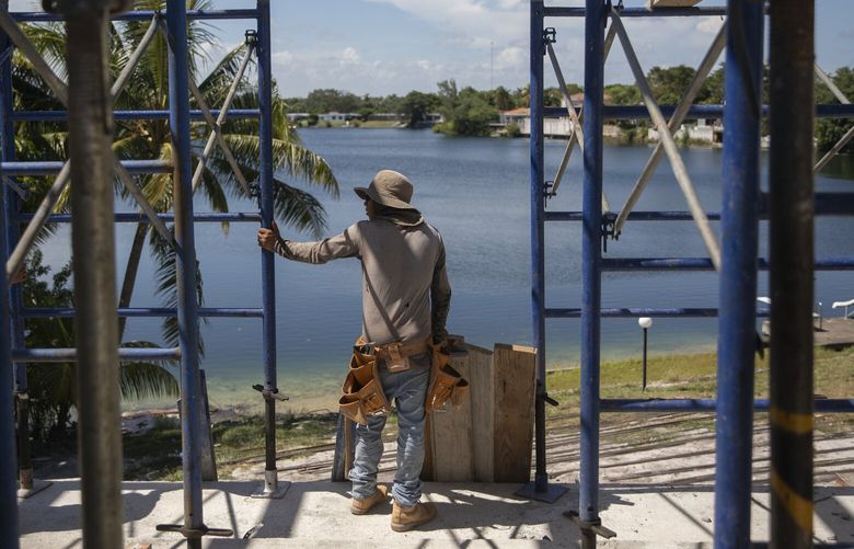 Cristian, a 14 year-old migrant, works on a construction site in North Miami, Fla. instead of going to school, on Aug. 30, 2022. Alone and exploited, migrant children who are arriving to the U.S. in record numbers are ending up in dangerous jobs that violate child labor laws — including in factories that make some of the country’s best-known products. (Kirsten Luce/The New York Times) XNYT1 XNYT1