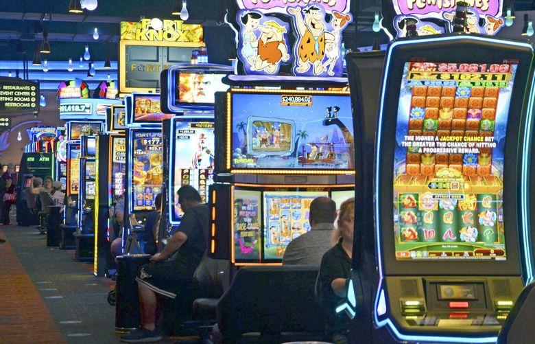 FILE — Slot machines at the FireKeepers Casino Hotel, owned and operated by the Nottawaseppi Huron Band of the Potawatomi, are seen in Battle Creek, Mich., Aug. 5, 2019. The casino shut down in the early months of COVID-19 pandemic, but the financial impact was blunted in part by the tribe’s non-gambling businesses, including a firm involved in drone development for the federal government that was deemed “essential.” (Nick Buckley/Battle Creek Enquirer via AP, File) MIBAT503 MIBAT503