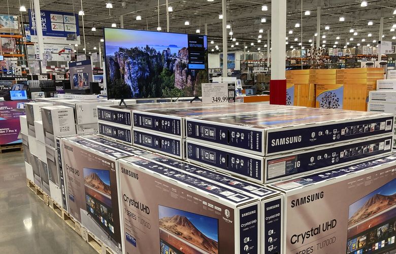 Big-screen televisions are displayed in a Costco warehouse Monday, Feb. 21, 2023, in Sheridan, Colo. (AP Photo/David Zalubowski) 