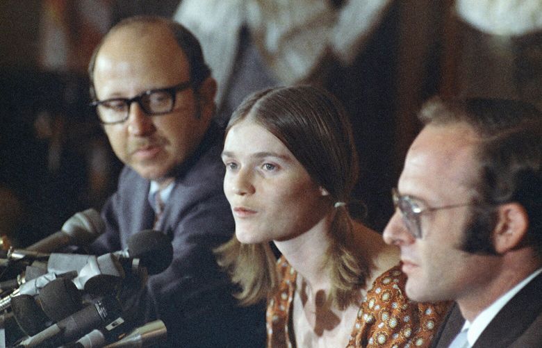 Linda Kasabian, center, is shown at press conference she held at end of her 18 days on stand as a prosecution witness in Sharon Tate Murder trial, Aug. 19, 1970, Los Angeles, Calif. Attorneys are Roland Goldman at her left, and Gary Fleischman at her right. (AP Photo/David F. Smith)