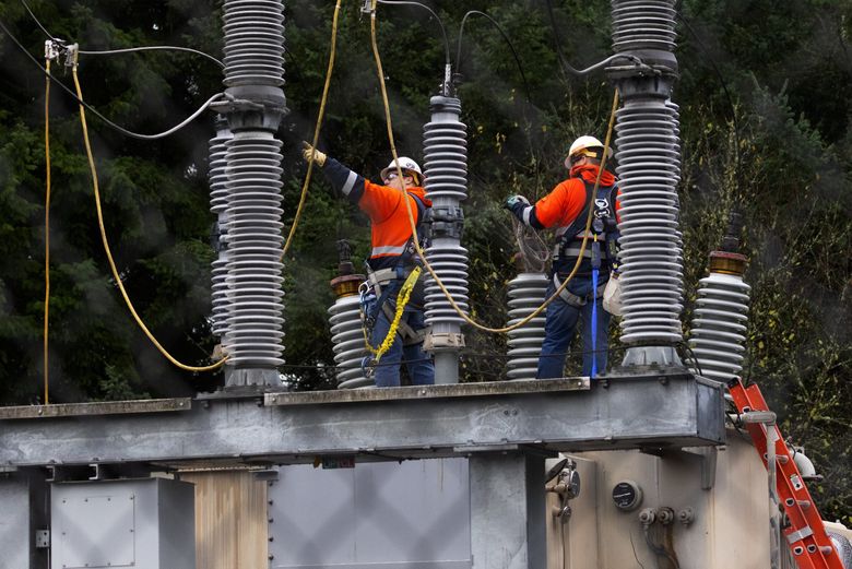 A Tacoma Power crew works at an electrical substation attacked early Christmas morning 2022. (Ken Lambert / The Seattle Times)