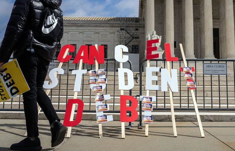 FILE – A sign urging the cancellation of student debt during a demonstration outside the Supreme Court in Washington on Tuesday, Feb. 28, 2023, as the court heard arguments over President Joe Biden’s plan to forgive some student debt. The court’s decision on whether to block the student loan program as well will have vast implications for millions of borrowers. (Haiyun Jiang/The New York Times) XNYT142 XNYT142