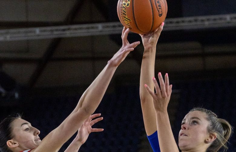 Bothell’s Ashlyn Peterson has her shot partially blocked by Kamiakin’s Maddy Rendall Wednesday afternoon in a 4A girls elimination game during the 2023 Hardwood Classic in Tacoma, Washington on March 1, 2023. The Bothell Cougars lost 62-52 to end their season.