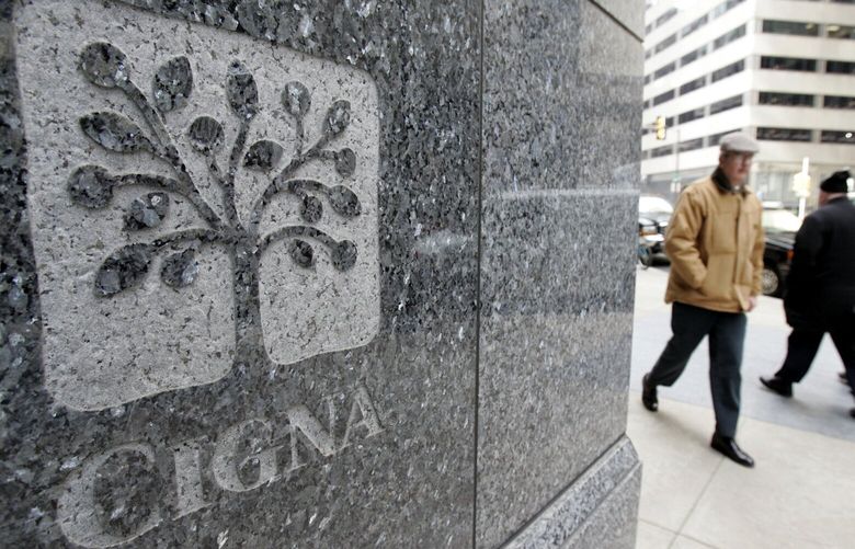 FILE – In this Feb. 8, 2006 file photo, pedestrians walk past the headquarters of the health insurer Cigna Corp. in downtown Philadelphia. Managed care company Cigna Corp. said Thursday, Nov. 5, 2009, its third-quarter profit soared 92 percent, as improving equity markets spurred a big turnaround in a business segment that hurt the insurer last year.(AP Photo/Jacqueline Larma, File) NYBZ142