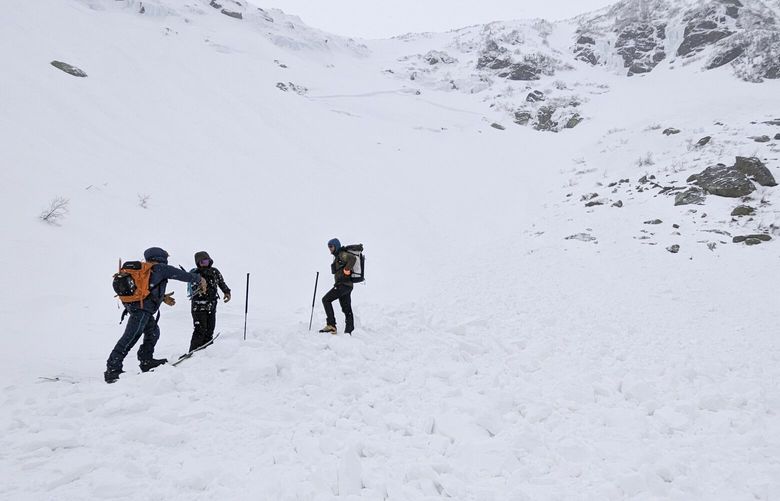This photo provided by Mount Washington Avalanche Center shows three staffers with the Avalanche Center investigating an avalanche on Mount Washington on Saturday, Feb. 25, 2023, in N.H. (Jeff Fongemie/Mount Washington Avalanche Center via AP) NHHO403 NHHO403