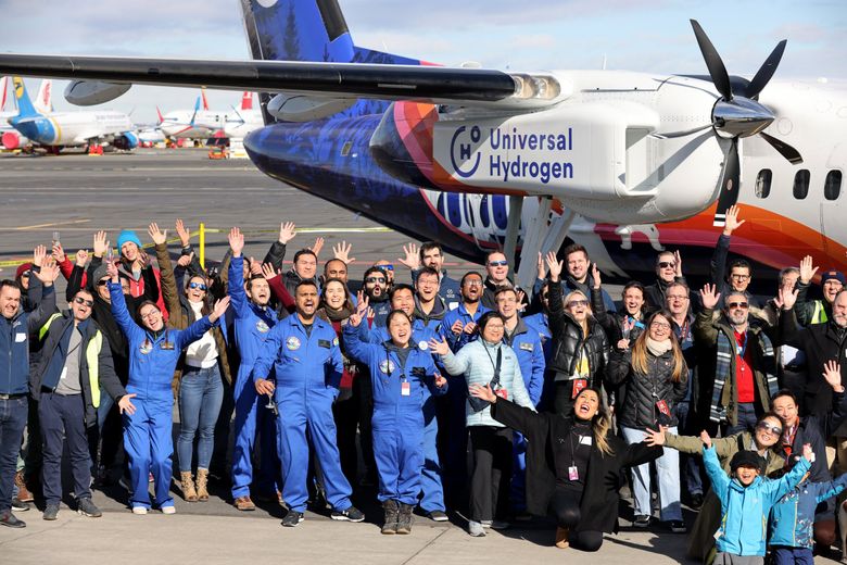 Crews, investors, partners, sponsors, friends and family members pose for a photo taken by Universal Hydrogen contract drone photographers in Moses Lake on Thursday as they celebrate the first flight of a regional airplane retrofitted by Universal Hydrogen to fly on hydrogen power. (Karen Ducey / The Seattle Times)