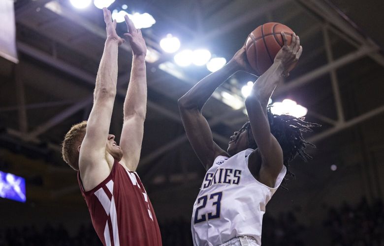 Washington guard Keyon Menifield shoots against Washington State guard Jabe Mullins during the first half of an NCAA college basketball game Thursday, March 2, 2023, in Seattle. (AP Photo/Stephen Brashear)