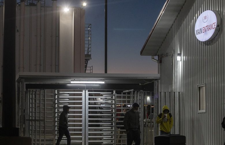 FILE — Young workers exit JBS pork plant after an overnight cleaning shift in Worthington, Minn. on Oct. 18, 2022. Members of Congress are pressing for changes to the law and the Biden administration’s approach as federal and state enforcement agencies begin a crackdown on companies that employ underage migrants. (Kirsten Luce/The New York Times) XNYT131 XNYT131