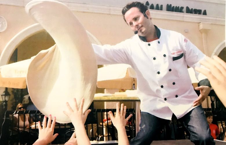 Tony Gemignani tossing pizza for a crowd of children in Boca Raton, Fla., in 2008. MUST CREDIT: Courtesy of Tony Gemignani