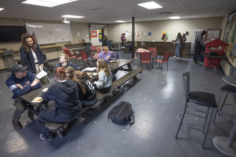 Renea Freeman, who coordinates the Gear Up program at Wahkiakum High School in Cathlamet, left, speaks to students in the school&#8217;s small cafeteria. Gear Up seeks to prepare for students for post-high school education. (Ellen M. Banner / The Seattle Times)
