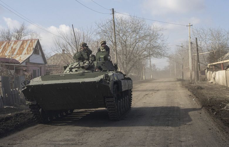 A Ukrainian APC drives towards frontline positions near Bakhmut, Ukraine, Saturday, March 4, 2023. (AP Photo/Evgeniy Maloletka) MAL104 MAL104